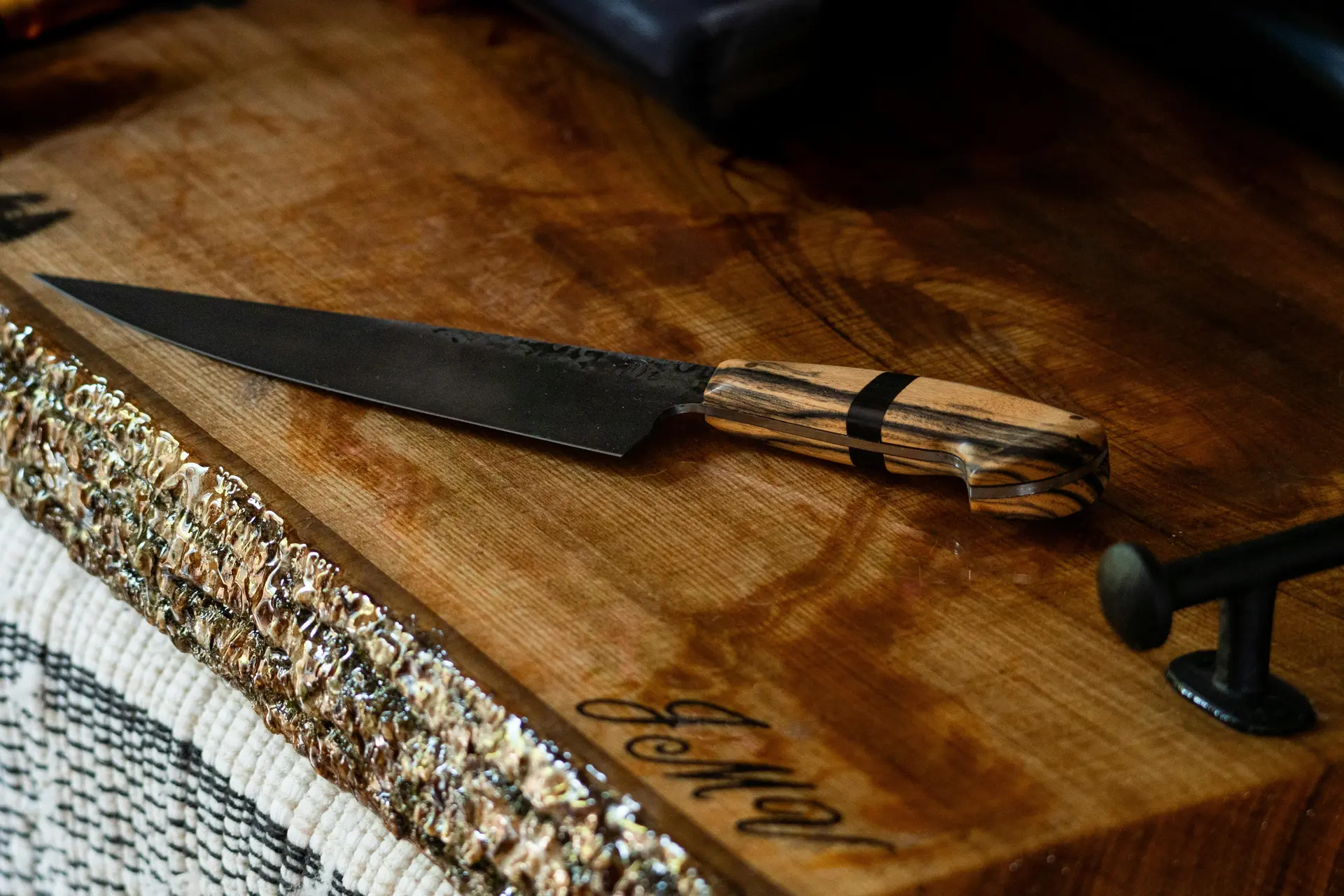 Artisan Japanese knife on rustic cutting board — gyutoguru.com